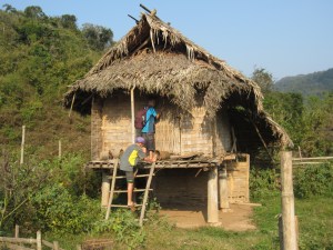 Boys explore hut in abandoned village