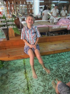 Braxton getting a (ticklish?) foot treatment at Dr. Fish, Khao San Rd., Bangkok, Thailand