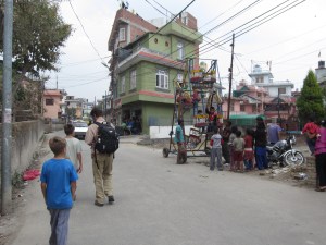 Strolling home past hand-cranked ferris wheel, Boudha, Nepal